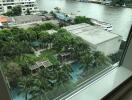 View from window overlooking pool, greenery, and river