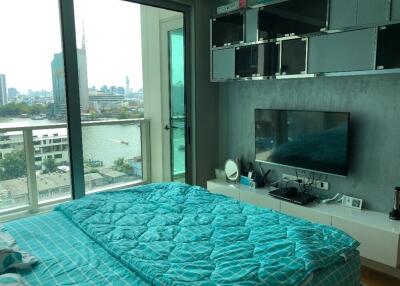 Modern bedroom with glass door and view of city skyline