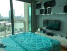 Modern bedroom with glass door and view of city skyline