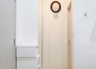 Minimalist hallway with wooden flooring and hat on wall hook