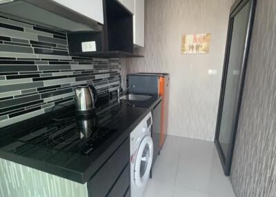 Modern kitchen with black countertop and appliances