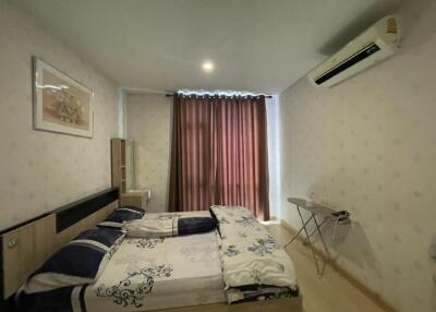 Spacious bedroom with double bed, air conditioning, and large window