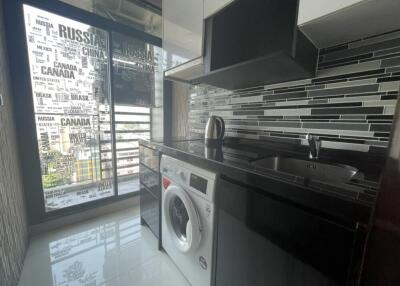 Modern kitchen with washing machine and stylish backsplash