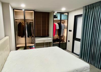 Spacious bedroom with large bed and wardrobe