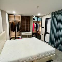 Spacious bedroom with large bed and wardrobe