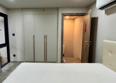 Modern bedroom with built-in wardrobe and air conditioning