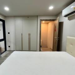 Modern bedroom with built-in wardrobe and air conditioning