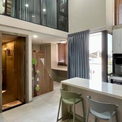 Modern kitchen area with breakfast bar and high ceiling