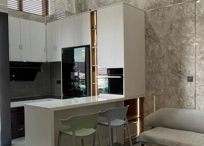 Modern kitchen with high ceiling and dining area