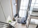 Modern living room with a loft-style layout, large windows, and contemporary furnishings