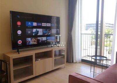 Living room with TV and balcony view