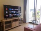 Living room with TV and balcony view