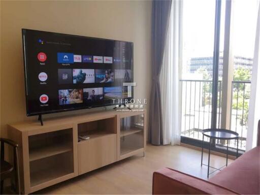 Living room with TV and balcony view