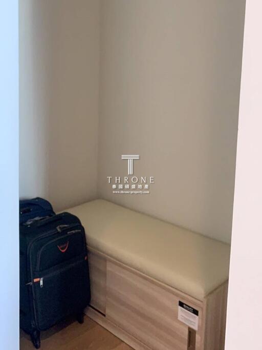 small storage area with luggage and bench