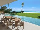 Luxurious beachside outdoor living space with dining table and infinity pool