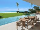 Outdoor seating area with pool and ocean view