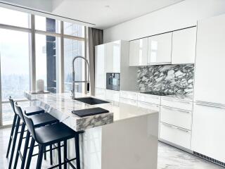 Modern kitchen with marble countertop and city view