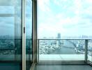 City skyline view from apartment balcony with glass door