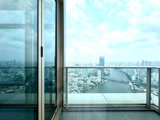 City skyline view from apartment balcony with glass door