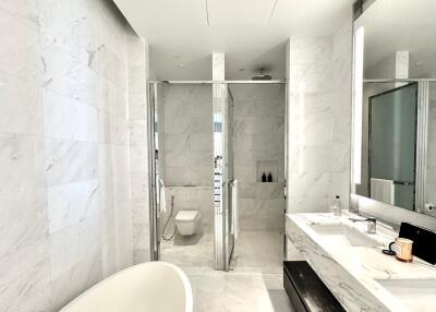 Modern bathroom with marble tiles and glass shower