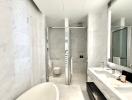 Modern bathroom with marble tiles and glass shower