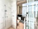 Modern bathroom with glass enclosure and city view