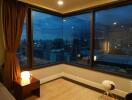 Bedroom with city view at dusk