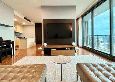 Modern living room with a large TV, piano, and a view of the city