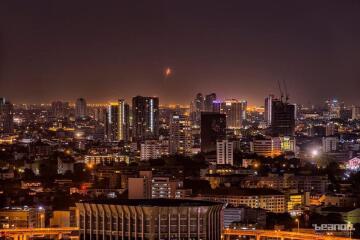 Night view of cityscape with high-rise buildings and illuminated streets