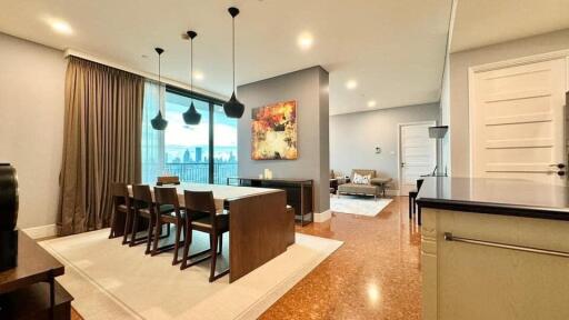 Modern open-concept living and dining area with large windows