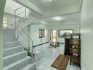 Spacious living area with staircase and tiled flooring