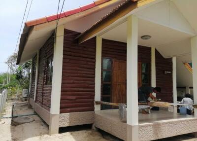 Exterior view of a wooden house with a porch