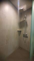 Modern shower space with overhead and handheld showerheads