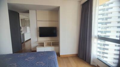 Bedroom with TV and large window