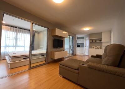 Modern living room with adjacent bedroom