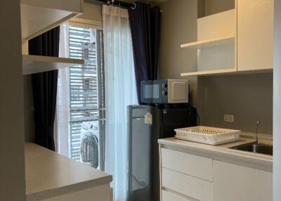 Modern kitchen area with appliances and shelves