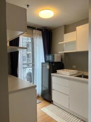 Modern kitchen area with appliances and shelves