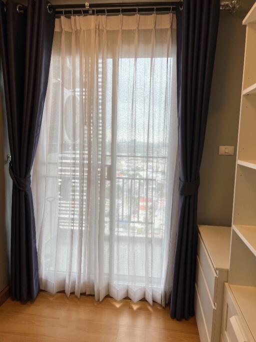 Bedroom with curtains and view of the city