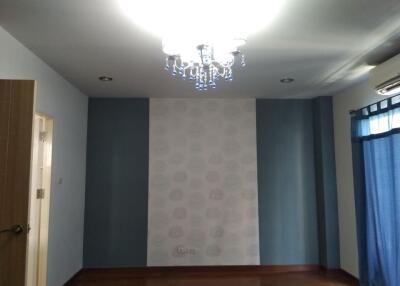 Bedroom with chandelier and blue walls