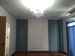 Bedroom with chandelier and blue walls