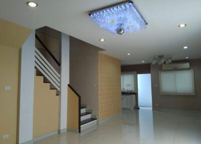 Modern living room with staircase and ceiling lights