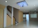 Modern living room with staircase and ceiling lights