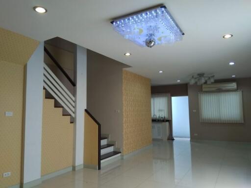 Modern living room with staircase and ceiling lights