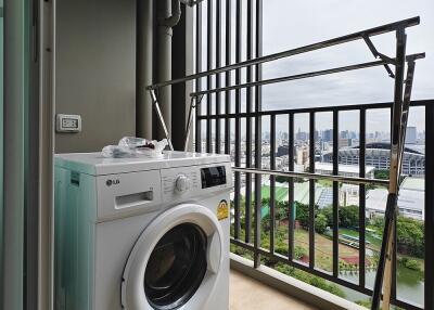 Laundry area with washing machine and drying rack