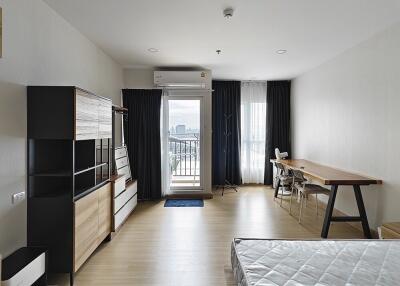 View of clean, modern main living area with large window and balcony access