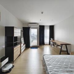 View of clean, modern main living area with large window and balcony access