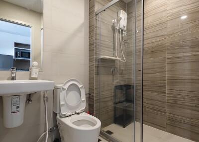 Modern bathroom with shower, toilet, and sink