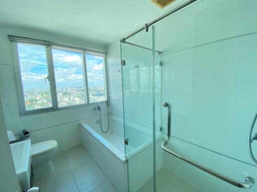 Bathroom with large window and city view