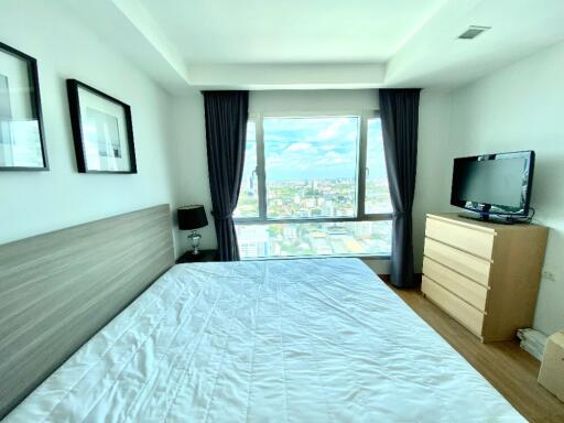 Bright bedroom with large window and city view