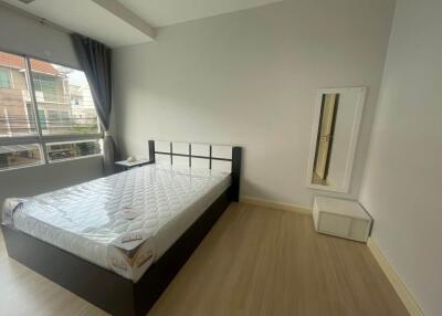 Bedroom with a bed, nightstand, mirror, and window